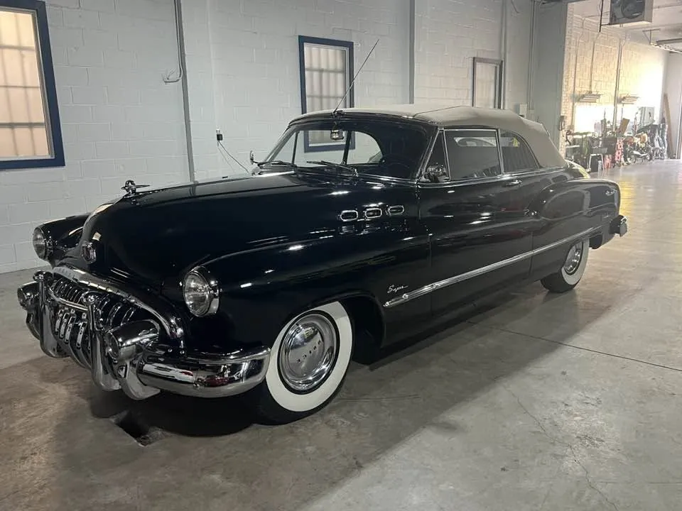 A black 1950 Buick Super convertible with whitewall tires parked inside Gateway Storage’s heated, climate-controlled building